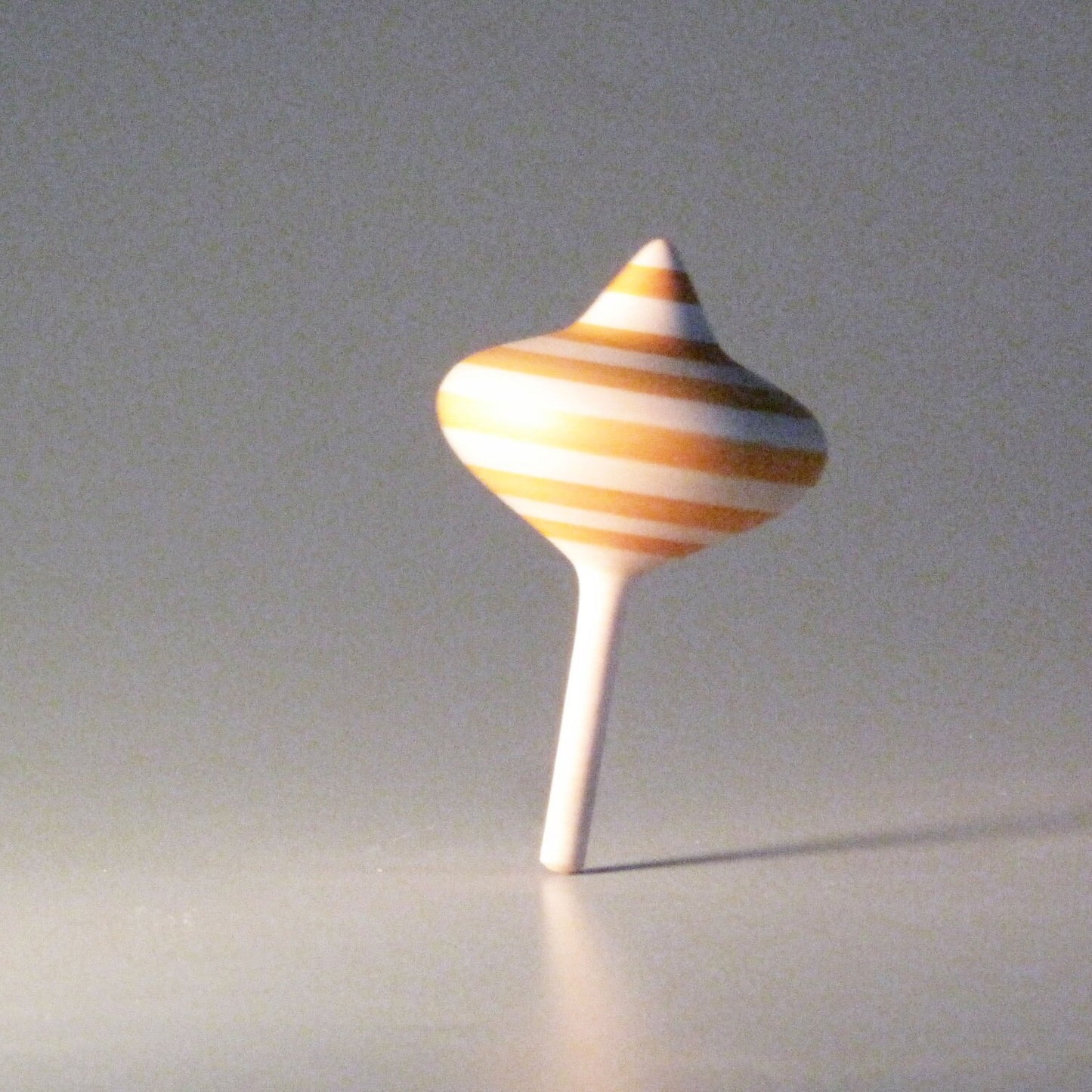 Onion-shaped spinning top with orange stripes