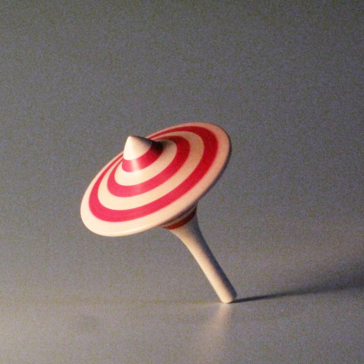 Red striped funnel shaped spinning top